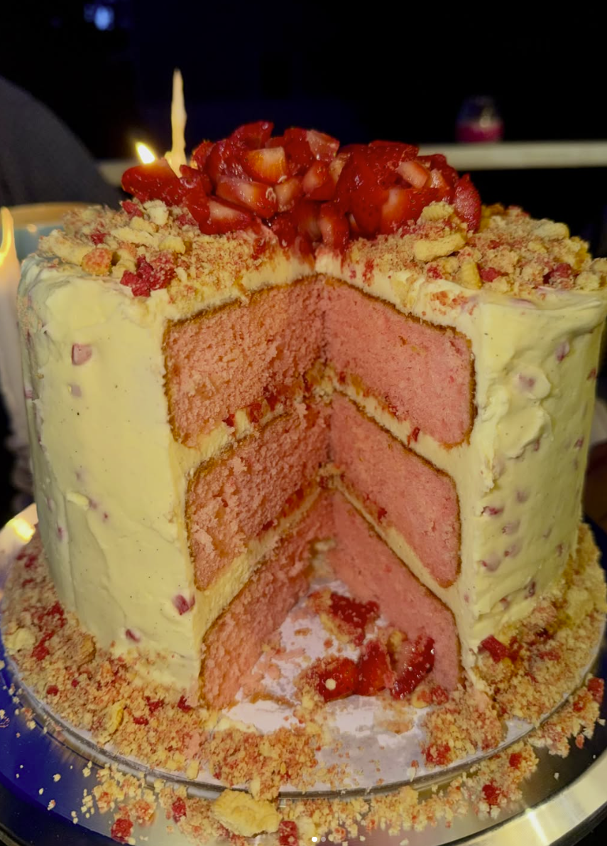Birthday cake with macarons and golden accents